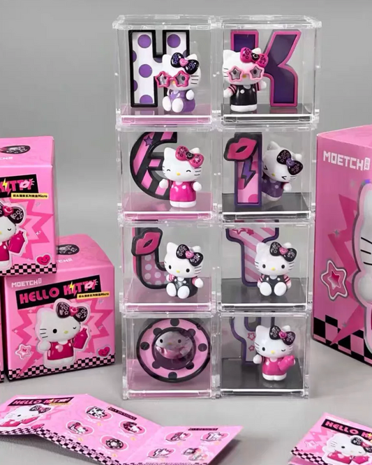 A Hello Kitty collectible display set featuring a stack of clear acrylic display boxes with small Hello Kitty figures and pink decorative inserts, alongside pink Hello Kitty boxes and a large pink product box on a gray studio background.