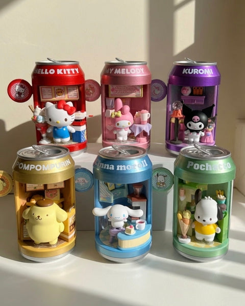 Six Sanrio-themed miniature toy can figures arranged on a white surface in warm sunlight. The figures resemble soda cans with character interiors: Hello Kitty in red, My Melody in pink, Kuromi in purple, Pompompurin in tan, Cinnamoroll in blue, and Pochacco in green.